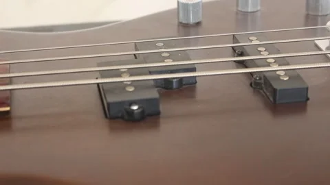 Strings and deck of the brown guitar Stock Footage 241659295