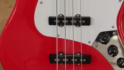 Strings and the deck of the red electrical guitar Stock Footage 241659403