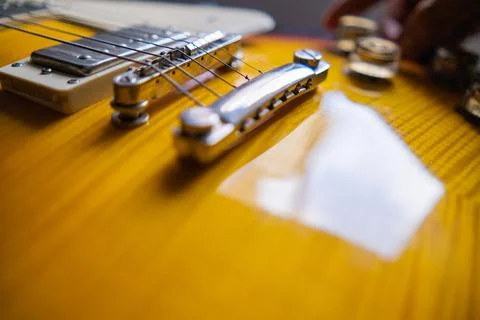 Strings and pickups of classic yellow and black electric guitar Stock Photos