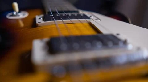 Strings and switch of classic brown and black electric guitar Stock Photos
