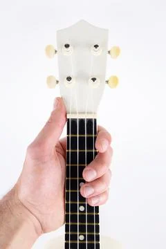 Strings of a beautiful white guitar close-up on a white background ukulele in Foto stock