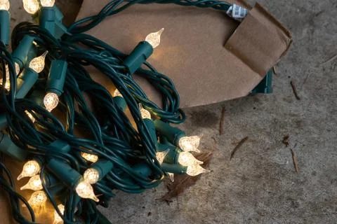 Strings of christmas lights hanging down ready to decorate a home Foto stock