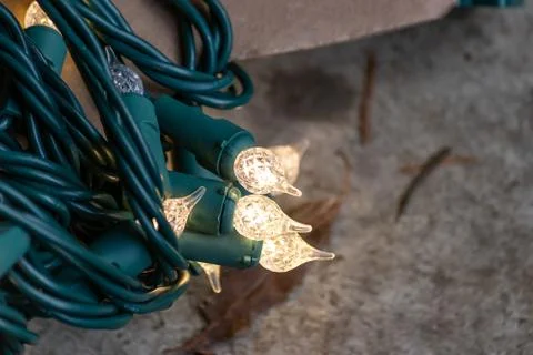 Strings of christmas lights hanging down ready to decorate a home 스톡 사진