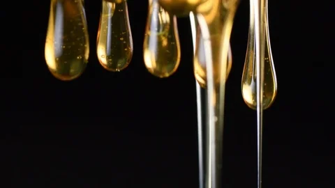Strings of Honey Drips On Black Background Video stock 88834439