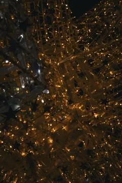 Strings of lights shine brightly at a nighttime event in a city square duri.. Stock Photos