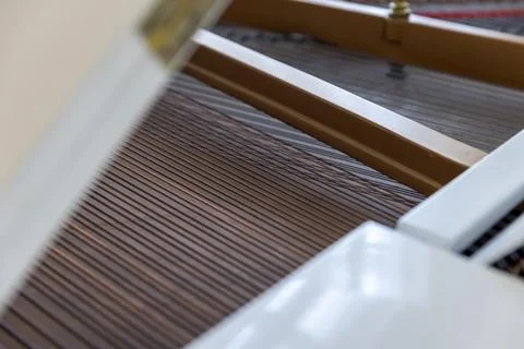 Strings of an old grand piano inside the instrument, details of the interna.. Stock Photos