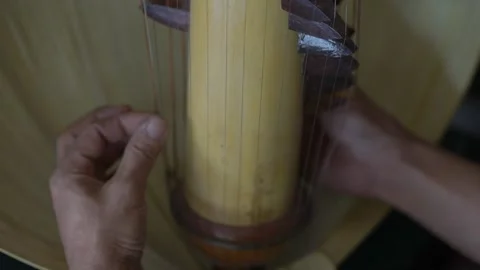 Strings of Tradition: The Artist's Touch Stock Footage 285383072