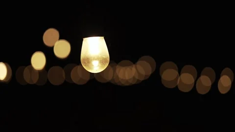 Strings of vintage edison light bulbs lighting up a dark night. Stock Footage 289595001