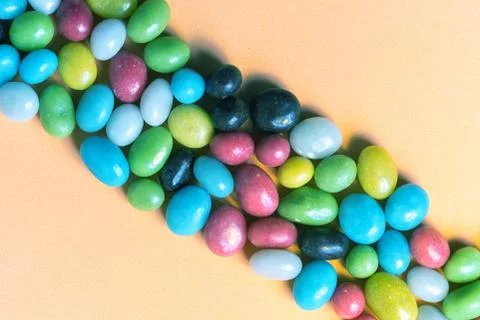 The strip is collected from a set of multi-colored candy pebbles Foto stock