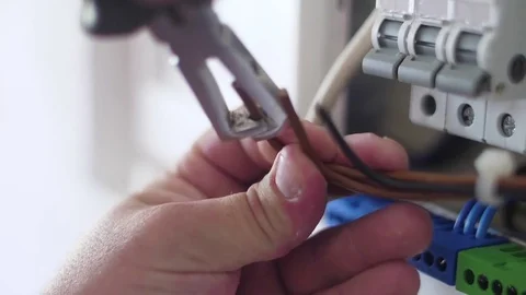 Strip electrical wire with plier in electric instalation slow motion Stock Footage 80789017