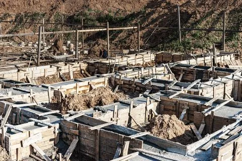 Strip foundations with formwork during the construction of a house. Photos
