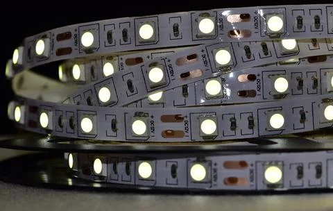 A strip of glowing low-power semiconductor LEDs of white light, connected to  Stock Photos