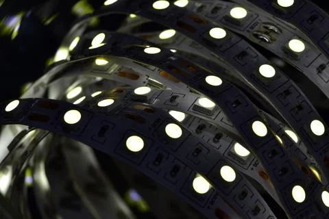 A strip of glowing low-power semiconductor LEDs of white light, connected to  Stock Photos