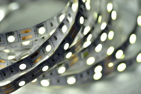 A strip of glowing low-power semiconductor LEDs of white light, connected to  Stock Photos
