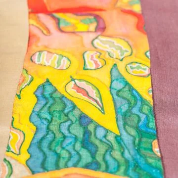 Strip of patchwork cloth with painted silk batik Stock Photos