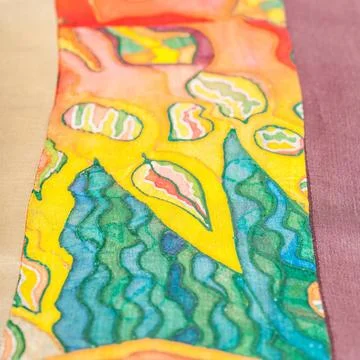 Strip of patchwork cloth with painted silk batik textile background - stri... Stock Photos