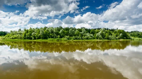 Stripe of Forest Between Cloudy Sky and the River Stock Footage 24950880