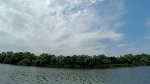 Stripe of Forest Between Cloudy Sky and River Stock Footage 56943020