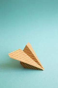 Stripe pattern kraft paper plane on green background. copy space Stripe pa... Stock Photos