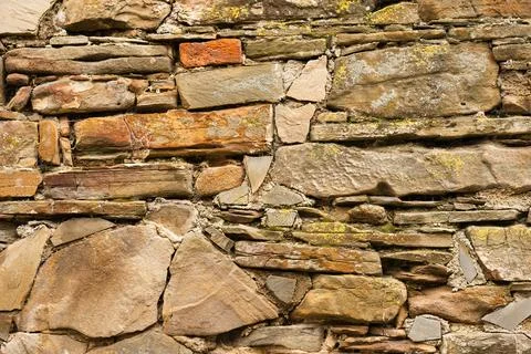Striped and rectangular stone wall pattern, texture. Horizontal photo Stock Photos