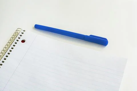 Striped blank notebook with pen. Spiral notepad and blue pen. Foto stock
