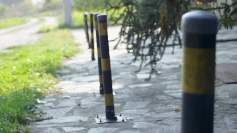 Striped bollards restricting access to private property. A line of columns in Stock Footage 315177544