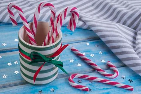 Striped ceramic cup with candy canes. Stock Photos