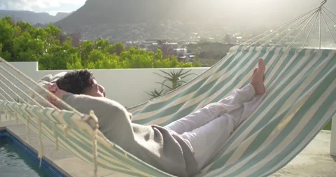 Striped hammock is swaying on rooftop pool terrace as camera is pushing closer, Stock Footage 341241168