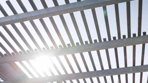 Striped metal construction frame being cover for parking lot, vehicles under the Video stock 308362237