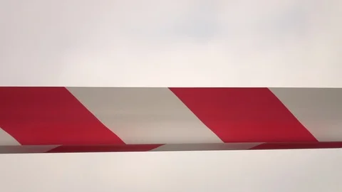 Striped protective tape on the wind in slow motion against white sky background. Vídeo Stock 125047296