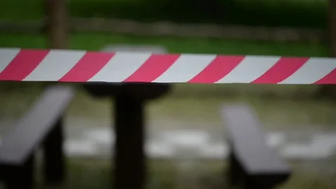 Striped red-and-white tape warns of dangerous area Stock Footage 79064768