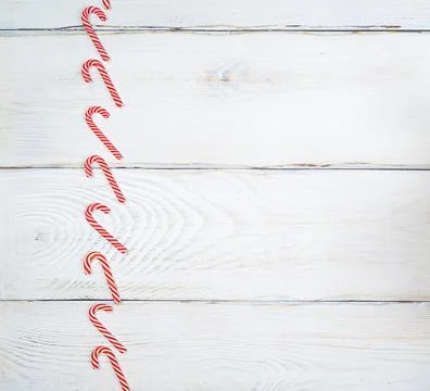 Striped red-white lollipops on a white wooden background Stock Photos