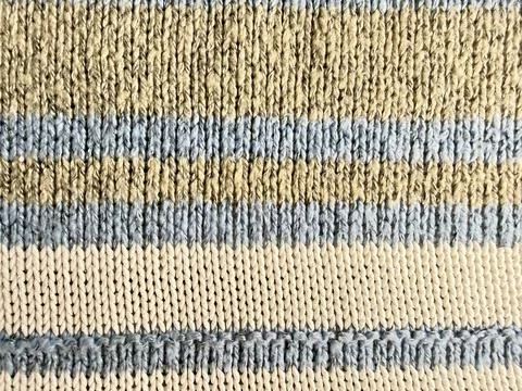 Striped ribbed knit cuff texture in beige blue cream wool closeup cozy earthy Stock Photos