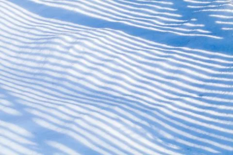 Striped shadow pattern on snow Stock Photos