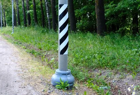 Striped sign on a pole. Stock Photos