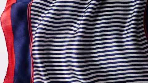 Striped silk fabric waves in the wind. Blue and white textile background. Video stock 333012136