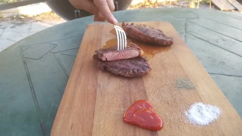 Striped steak. Roasting medium/medium well. Press the knife on the steak and sho Stock Footage 140185548