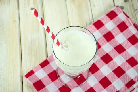 Striped straw in milk Stock Photos
