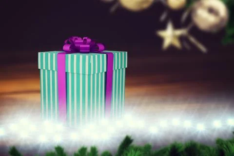 Striped teal gift box is sitting on floor in flat design with purple ribbon, Stock Illustration