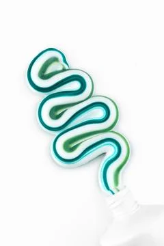 Striped toothpaste swirl on white background Stock Photos