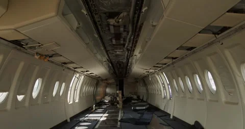 Stripped Cabin Interior of Dismantled Passenger Aircraft, Window Rows, Wide Shot Stock Footage 340307560