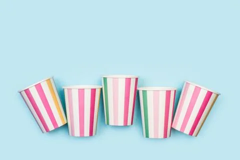 Stripped disposable cups on a light blue background Stock Photos
