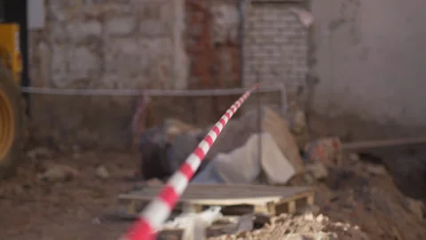 Stripped warning tape surrounds construction area Vídeo Stock 316086658