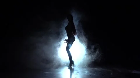 Stripper in the smoke dancing . Black smoke background. Silhouette. Slow motion Stock Footage 92096718