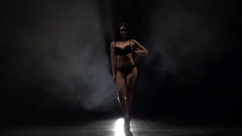 Stripper in the smoke dancing . Black smoke background. Silhouette. Slow motion Stock Footage 92096797