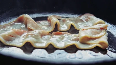 Strips fried bacon fried in a pan. Stock-Footage 77610811