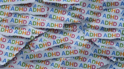 Strips of newspaper with the abbreviation ADHD typed on them. Stock Footage 335962040