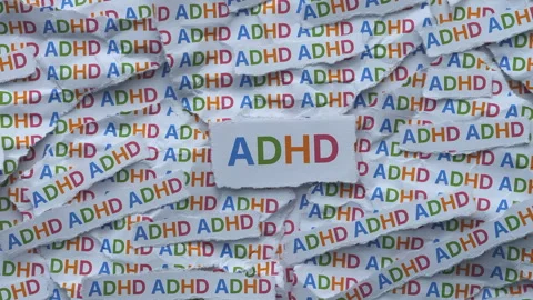 Strips of newspaper with the abbreviation ADHD typed on them. Stock Footage 336503632