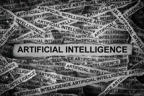 Strips of newspaper with the words Artificial Intelligence typed on them. Stock Photos