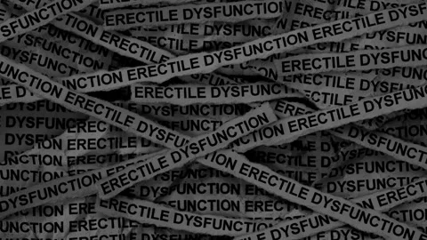Strips of newspaper with the words Erectile Dysfunction typed on them. Video stock 299650799